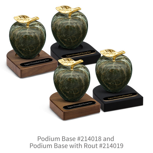 black and brown walnut podium bases with black brass plates and green marble apples