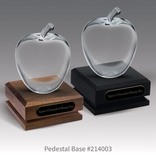 black and a brown walnut pedestal bases with black brass plates and large optic crystal apples