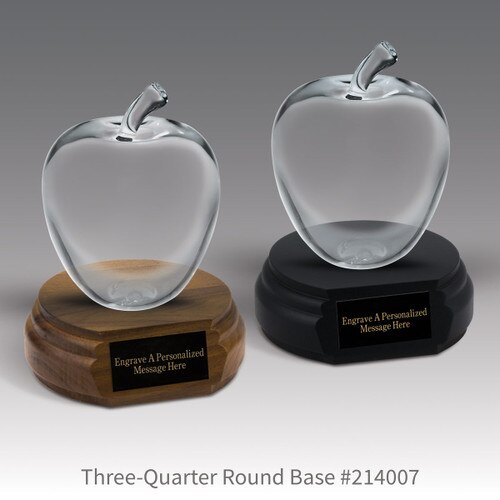 black and a brown walnut three-quarter round bases with black brass plates and large optic crystal apples