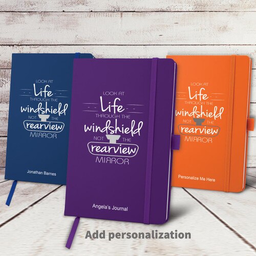 blue, purple, and orange hardbound journals with Look At Life message and personalization