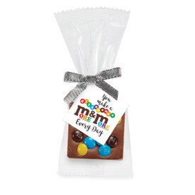 Bite-size Belgian chocolate square with M&M’s topping. Inspirational card reads “You make a difference more and more every day.”