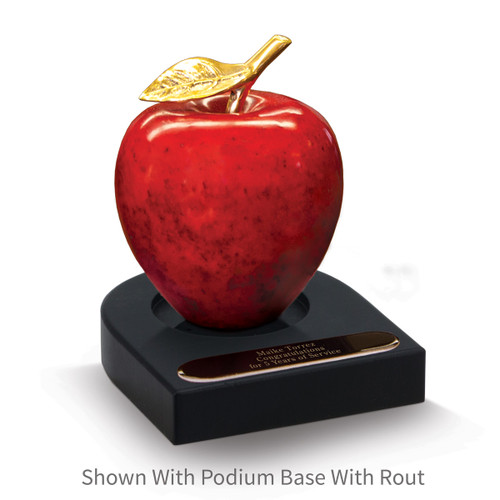 natural stone apple sitting on top a black walnut base with black brass plate