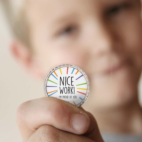 a boy holding a nice work coin
