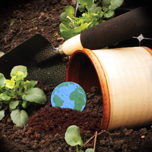 flower pot with dirt and shovel