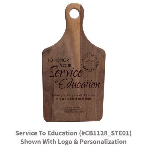 walnut paddle cutting board with service to education message