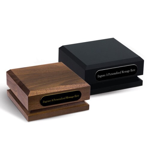 black and a brown walnut pedestal bases with personalized black brass plates