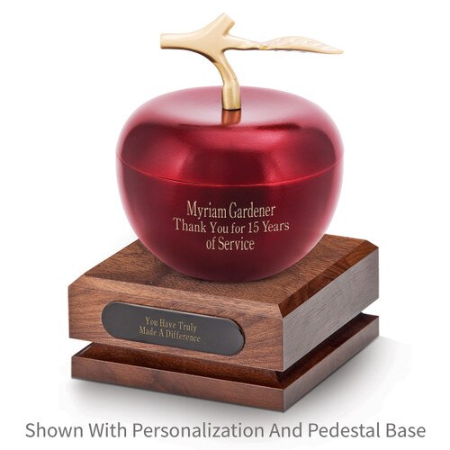 crimson apple dish sitting on top a walnut base with black brass plate