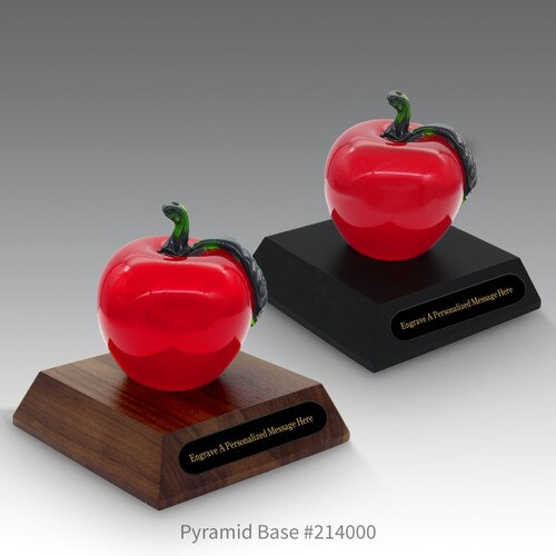 black and a brown walnut pyramid bases with black brass plates and red crystal apples