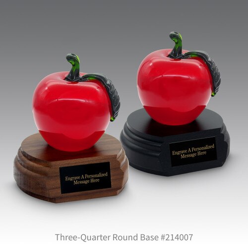 black and a brown walnut three quarter round bases with black brass plates and red crystal apples