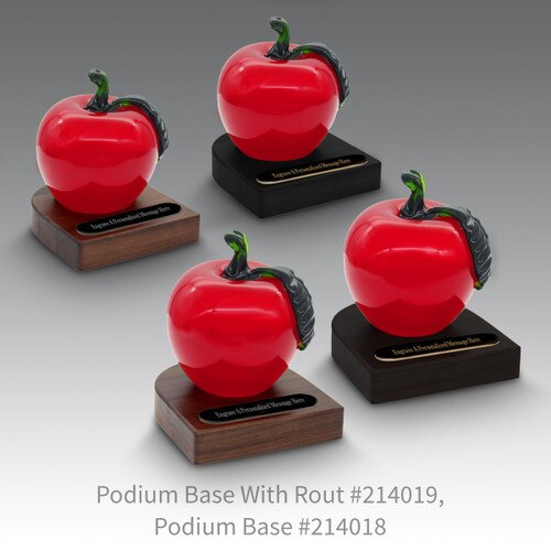 black and a brown walnut podium bases with black brass plates and red crystal apples