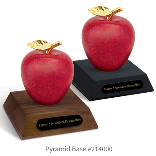 black and a brown walnut pyramid bases with black brass plates and marble apples
