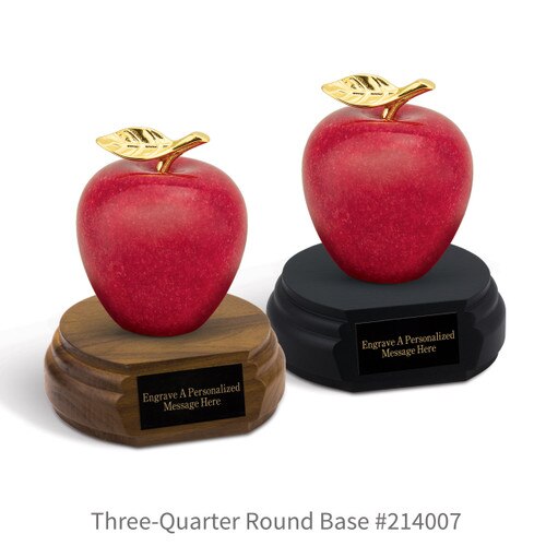 black and a brown walnut three-quarter round bases with black brass plates and marble apples