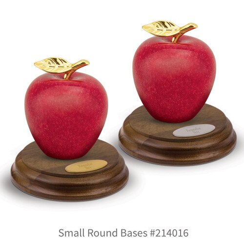 round walnut bases with brass and silver plates and marble apples
