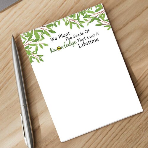 seeds of knowledge notepad with a pen sitting on a desk