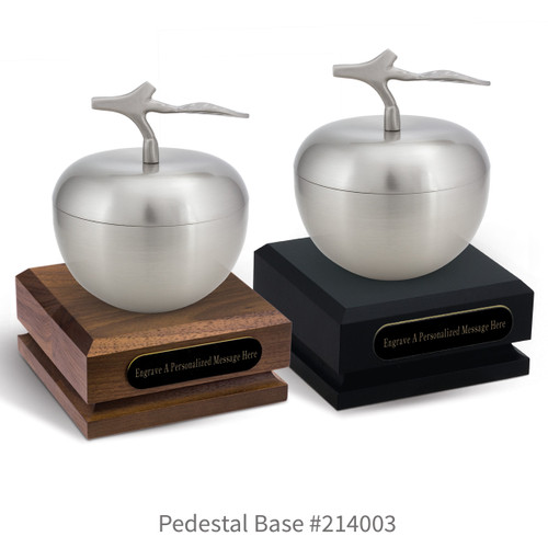 black and a brown walnut pedestal bases with black brass plates and silver apple dishes