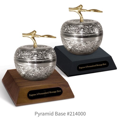 black and a brown walnut pyramid bases with black brass plates and silver embossed apple dishes