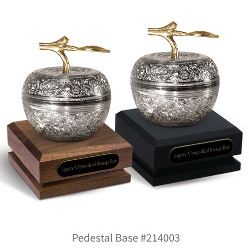 black and a brown walnut pedestal bases with black brass plates and silver embossed apple dishes