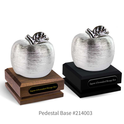 black and a brown walnut pedestal bases with black brass plates and silver spun apples