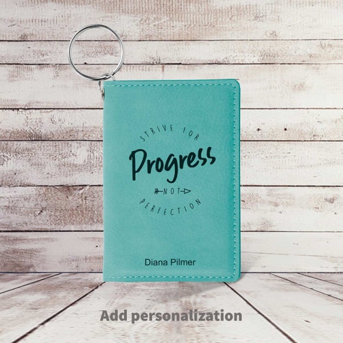 teal leather id card holder with strive for progress message