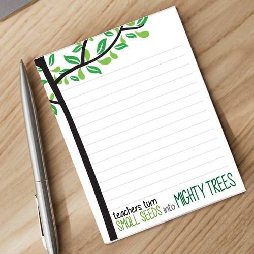 mighty tree notepad with a pen sitting on a desk