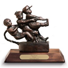 bronze statue of kids pulling a rope sitting on a walnut base with brass plate