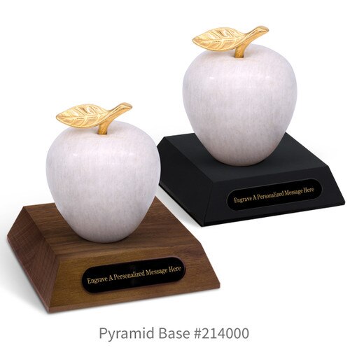black and a brown walnut pyramid bases with black brass plates and white marble apples