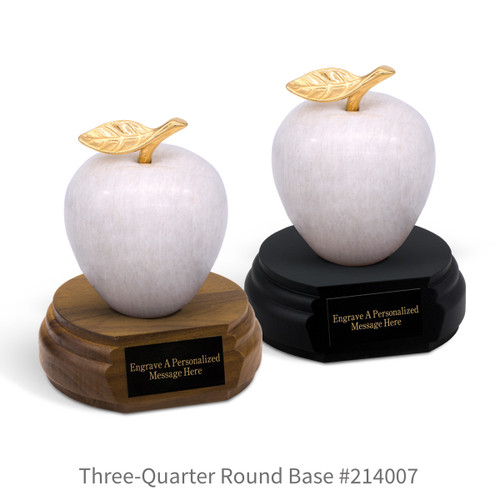 black and a brown walnut three-quarter round bases with black brass plates and white marble apples