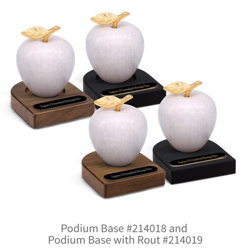 black and brown walnut podium bases with black brass plates and white marble apples