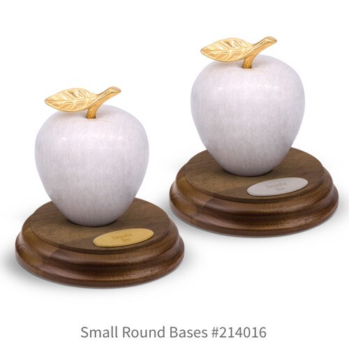 round walnut bases with brass and silver plates and white marble apples