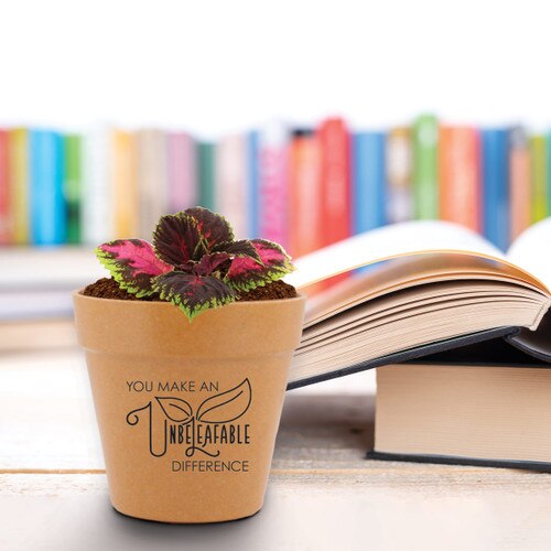 unbeleafable flower pot sitting on a desk