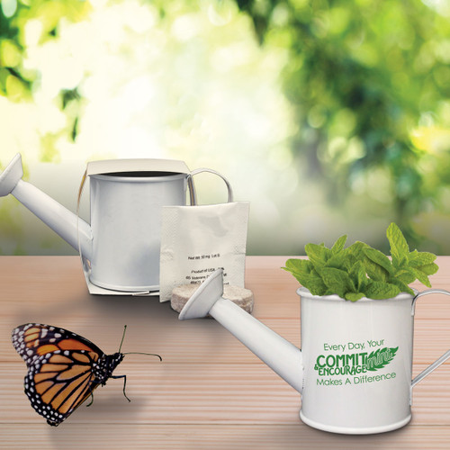 mint plant in mini watering can with a butterfly